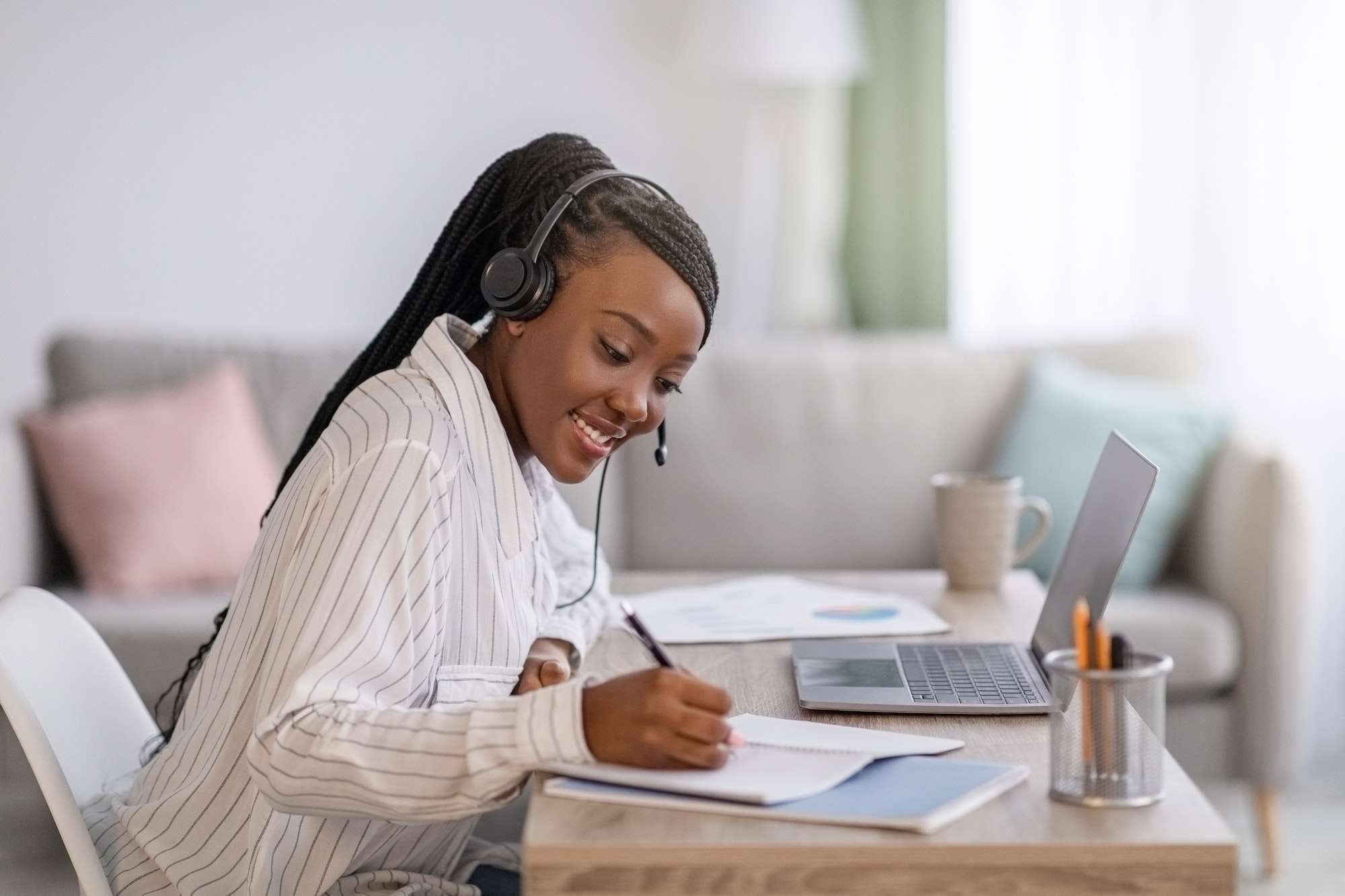 Joyful african american woman attending online course
