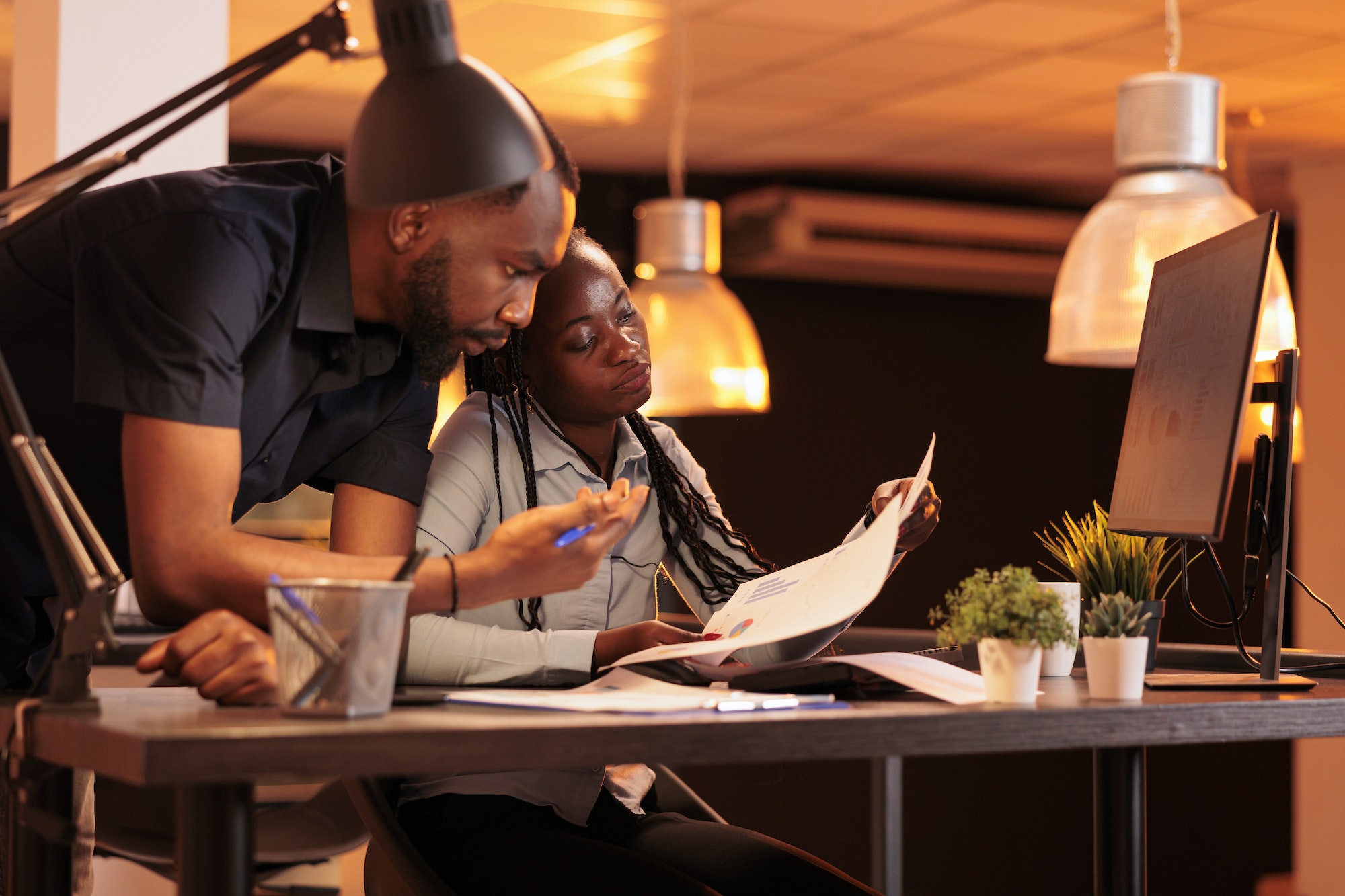 Team of african american business people analyzing paperwork